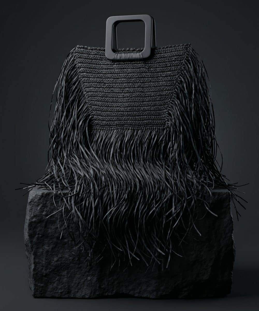 Leila Black Fringe Handbag siyah püsküllü el çantası doğal ışıkta mermer platform üzerinde lüks kadın aksesuarı