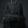Leila Black Fringe Handbag siyah püsküllü el çantası doğal ışıkta mermer platform üzerinde lüks kadın aksesuarı